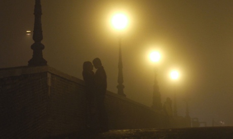A couple on a misty Milvio bridge in Rome