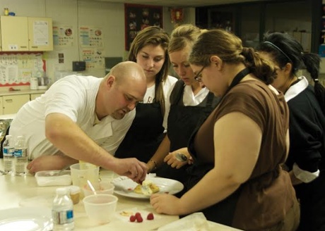 young people learning how to cook