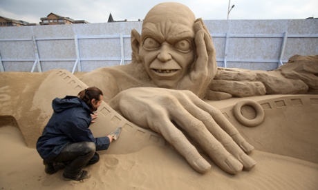 Man making a sand sculpture of Golem.
