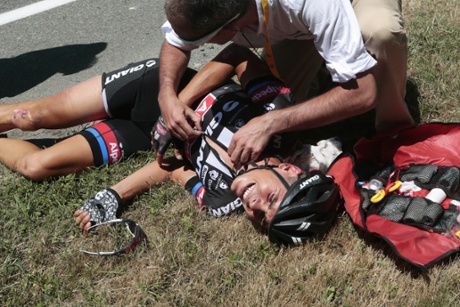 A medic tends to Warren Barguil after he crashed in the feeding zone.