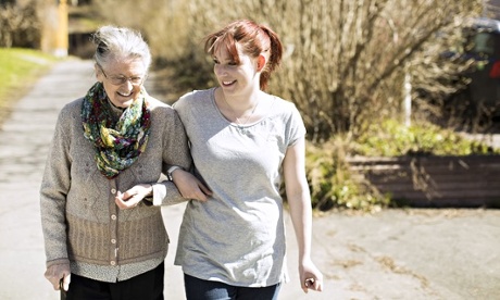 Old lady being helped by a young carer
