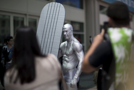 A cosplay enthusiast dressed like the Silver Surfer at Comic-Con.
