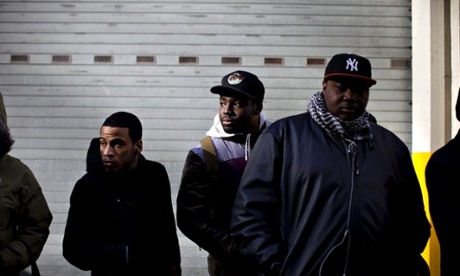 Job seekers listen to a womenjobfairs.com representative as they wait in line outside prior to the start of a job fair in New York, U.S., on Tuesday, Feb. 9, 2010.