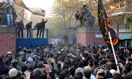 Protesters storm a security gate as they break into the British embassy in Tehran in 2011