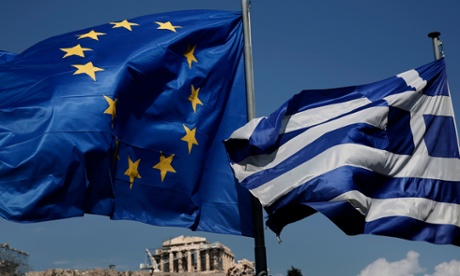 EU and Greek flags in front of the ancient Parthenon temple in Athens.