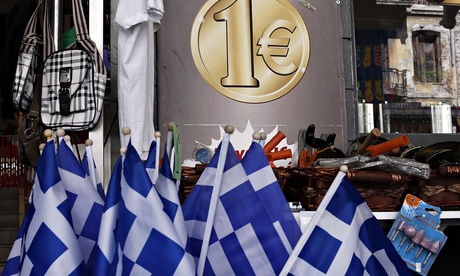 Greek national flags are displayed for sale at the entrance of a one Euro shop in Athens