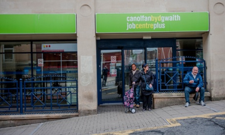 Waiting outside a Jobcentre Plus in Wales.