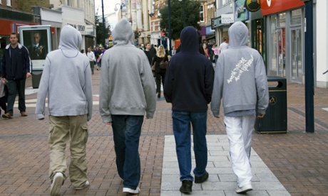 a group of young boys in hoodies.