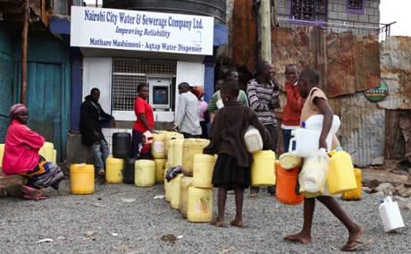 Kenyans queue at one of the new ATM-style water dispensers installed in the Mathare slums in Nairobi. The new system, which uses a smart card, aims to provide cleaner and cheaper water to slum-dwellers. 