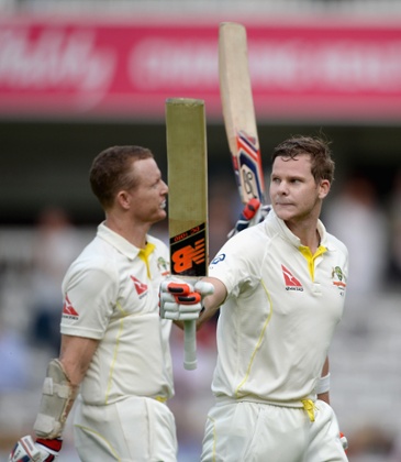 Australian unbeaten batsmen Chris Rogers and Steven Smith of Australia leave the field at the end of day one.