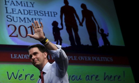 Scott Walker waves as he leaves the Family Leadership Summit in Ames, Iowa.