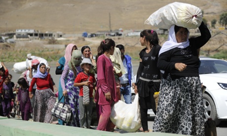 Displaced Yazidis cross the Tigris river as they make their way from Syria into Iraq.