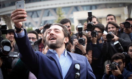 Iranian actor Bahram Radan takes selfie during the photocall for the film Ice Age at the Fadjr international film festival in Tehran.