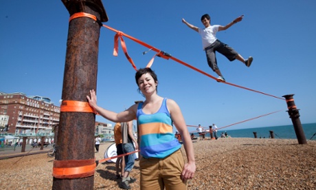 Rachel Dixon learns tries out slacklining on Brighton beach.