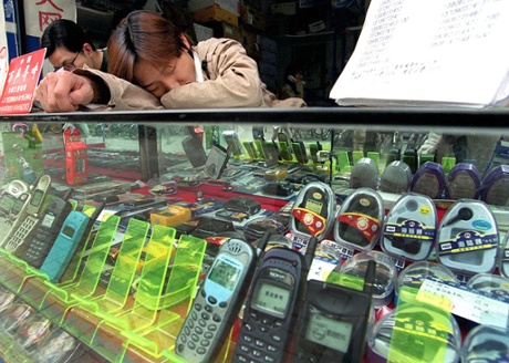 A vendor takes a nap on his counter in Shanghai. ‘China has a healthy napping culture’.