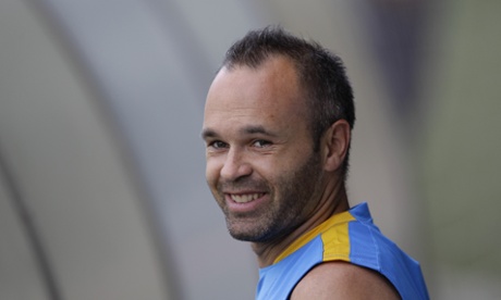 FC Barcelona's Andres Iniesta smiles during a training session at the Sports Center FC Barcelona Joan Gamper in the San Joan Despi, Spain, Wednesday, July 15, 2015.