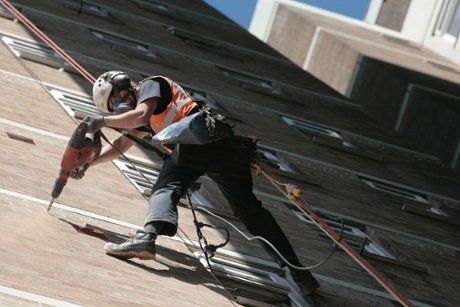 Industrial abseiler drilling building