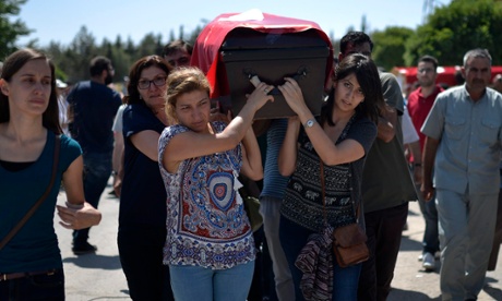 Friends and relatives carry the coffin of a victim of the Suruç bombing during a funeral in Gaziantep, Turkey, for 16 of the 32 people killed.