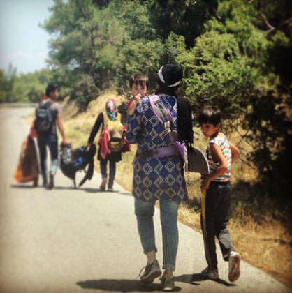 It's tough journey for kids and shade is scarce on the 70km route to the makeshift #refugee camp in Lesvos,