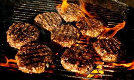Burgers and flames on a barbecue