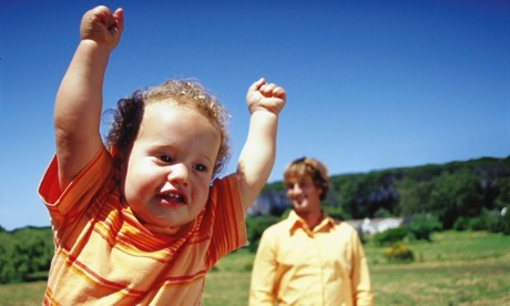 Happy baby with arms up in the air