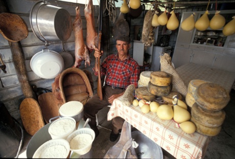 A producer poses with a wealth of Sardinian delicacies. 