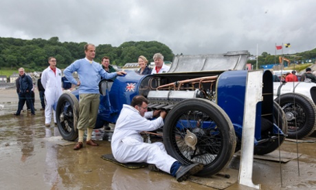 Don Wales stands in his grandfather's footsteps next to the famous car.