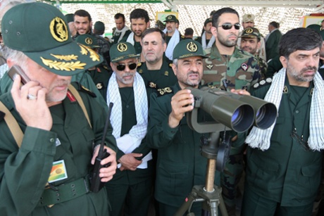 Revolutionary Guards commander Mohammad Ali Jafari monitors with binoculars during a war game in the Hormuz area of southern Iran.