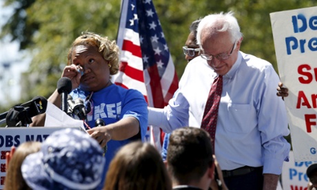Bernie Sanders comforts Sontia Bailey, a Capitol cafe cashier,  as she cries while telling her story at a rally calling for a national $15 minimum wage bill.