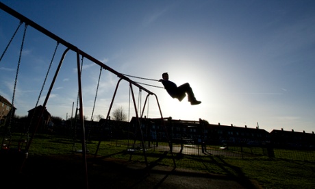 Child playing on swings.