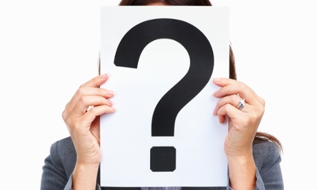 Woman with question mark covering her face.