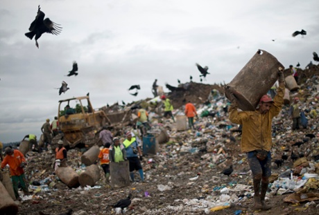 A group of 'catadores'  dig through trash at the Jardim Gramacho landfill in Rio de Janeiro 2012.