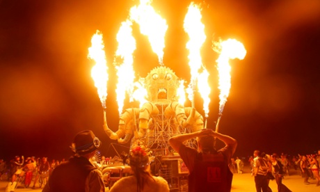 Participants watch the flames from El Pulpo Mecanico during the Burning Man 2012.