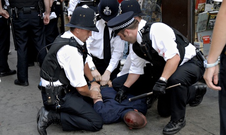 Police officers handcuffing a young male