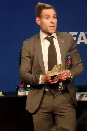 Simon Brodkin as Jason Bent gets ready to throw the cash.