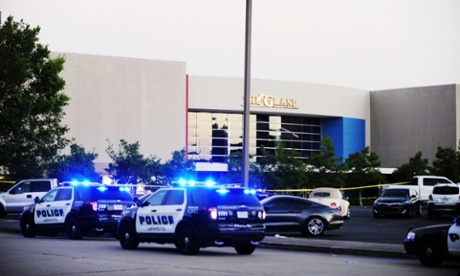 Law enforcement and other emergency personnel respond to the scene of the shooting at the Grand 16 movie theater.
