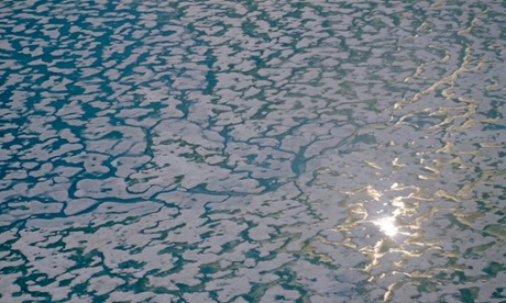 The sun glints off melting sea ice near Ellesmere Island.