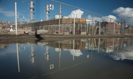 A gas processing plant built in front of a cemetary in Bloomfield New Mexico.  