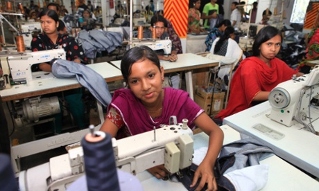 Women and girls operating sewing machines in clothes factory