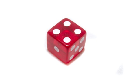 A red casino dice on white isolated background showing the number Four Captured in Langhus Norway 19 12 
