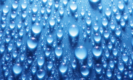 Shiny water drops on metallic blue surface