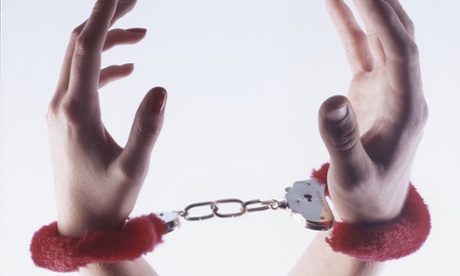 Male and female hands in red fluffy handcuffs Photograph: Peter Cade/Getty Images