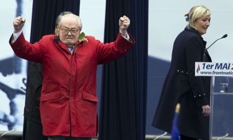France's Front National founder Jean-Marie Le Pen on stage as party president Marine Le Pen looks on during a rally.
