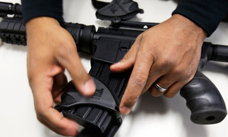 A New Haven police officer dismantles a Bushmaster semi-automatic assault rifle after it was turned in during a gun buyback event in 2012.