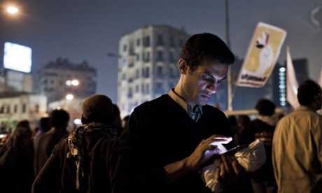 A protester uses a mobile phone 