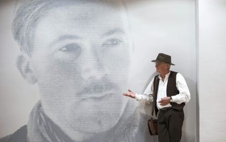 Chris Stewart, a founding member of Genesis, in front of a portrait of Gerald Brenan in the Brenan house-museum in Malaga, before giving a lecture on the pleasures of being a foreigner in Malaga.