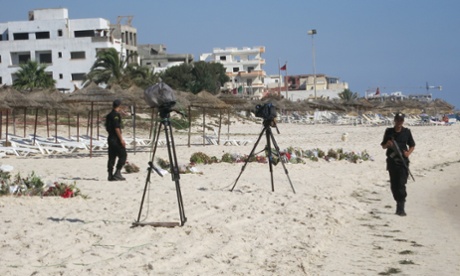 Tunisian police patrol the beach where ambassadors and Tunisian officials will hold a minute's silence to remember the victims of the Sousse attack.