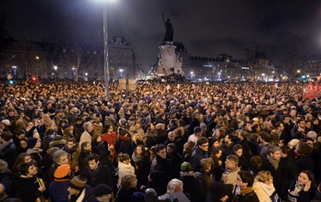 People gather at the Place de la République in Paris on the evening after the attack at the offices of Charlie Hebdo that left 12 people dead.