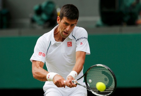 Novak Djokovic powers a return as he takes control of the first set against Tomic.