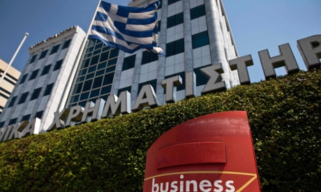 A Greek flag flutters outside the Athens stock exchange.